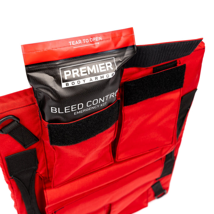 back view of first aid shield showing 4 pockets with stop the bleed kit sticking out of one