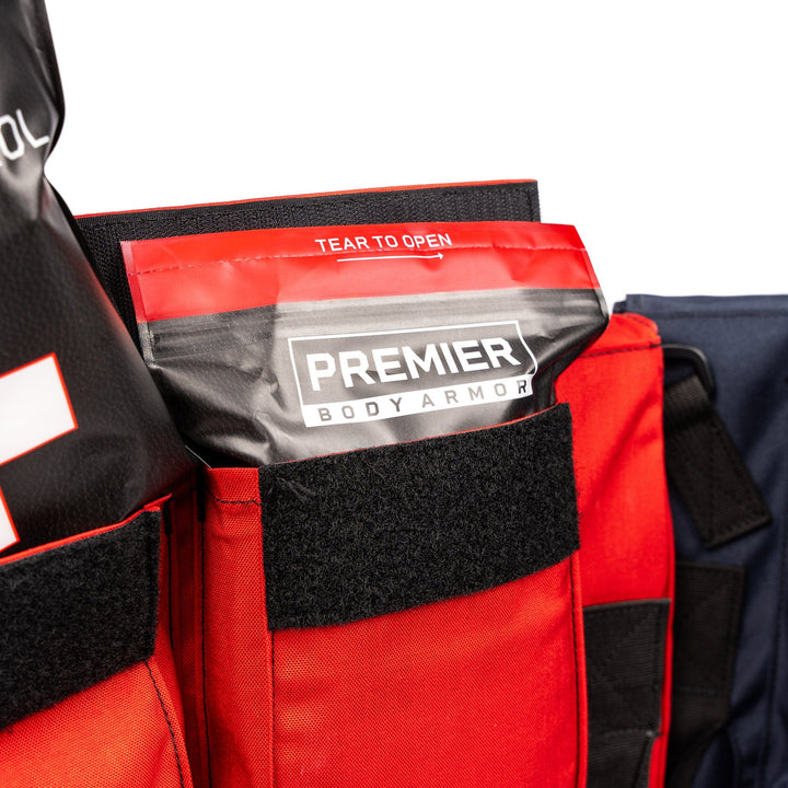 bleed control kit sticking out of pocket of first aid school shield