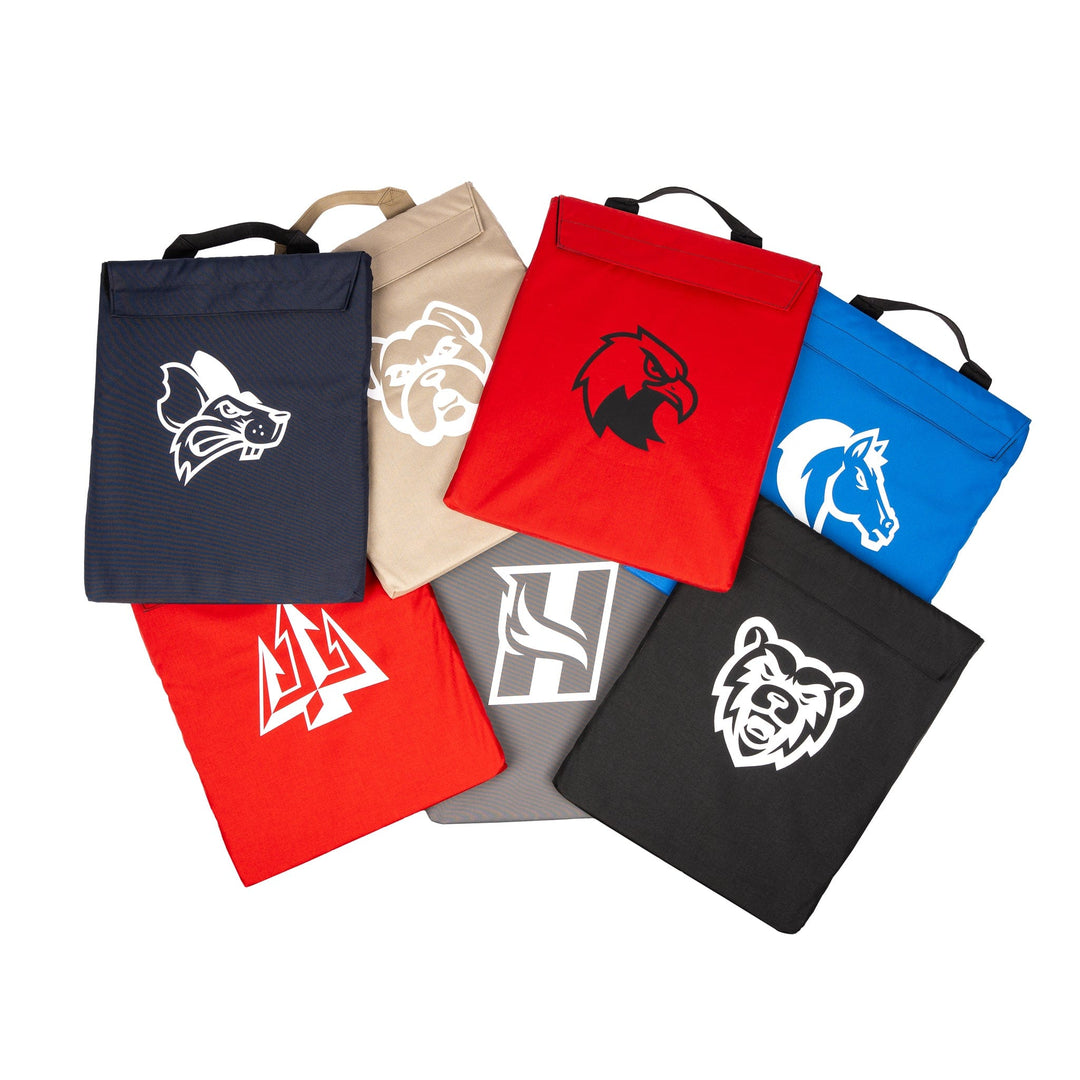 multiple colors of first aid shield cover with school mascots, including red, blue black, navy and grey.