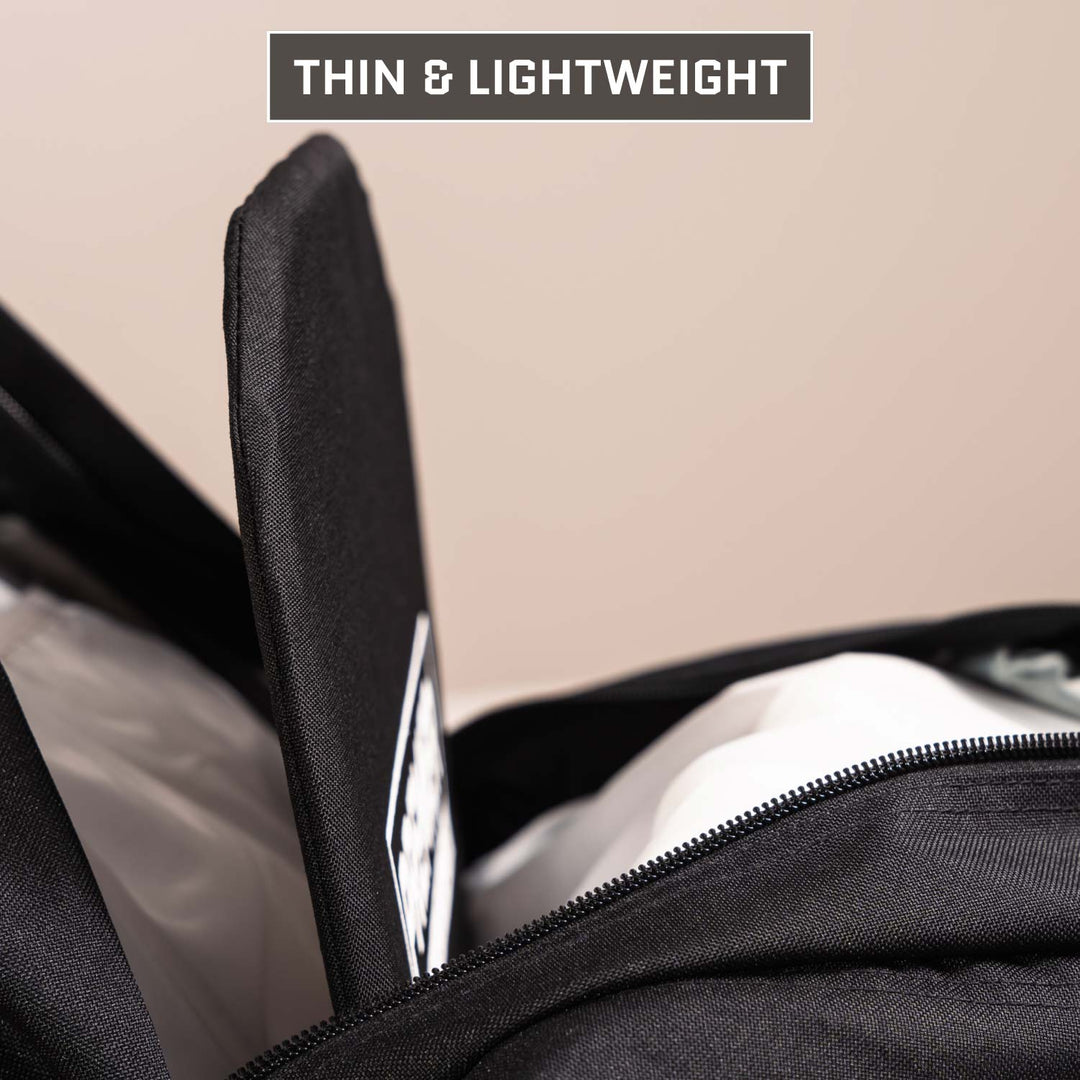 A close-up of a 5.11 Rush 24/72 Pack with an open zipper reveals a Premier Body Armor Level IIIA Insert being placed inside. Text at the top reads āTHIN & LIGHTWEIGHT.ā This insert meets NIJ ballistic standards for protection.