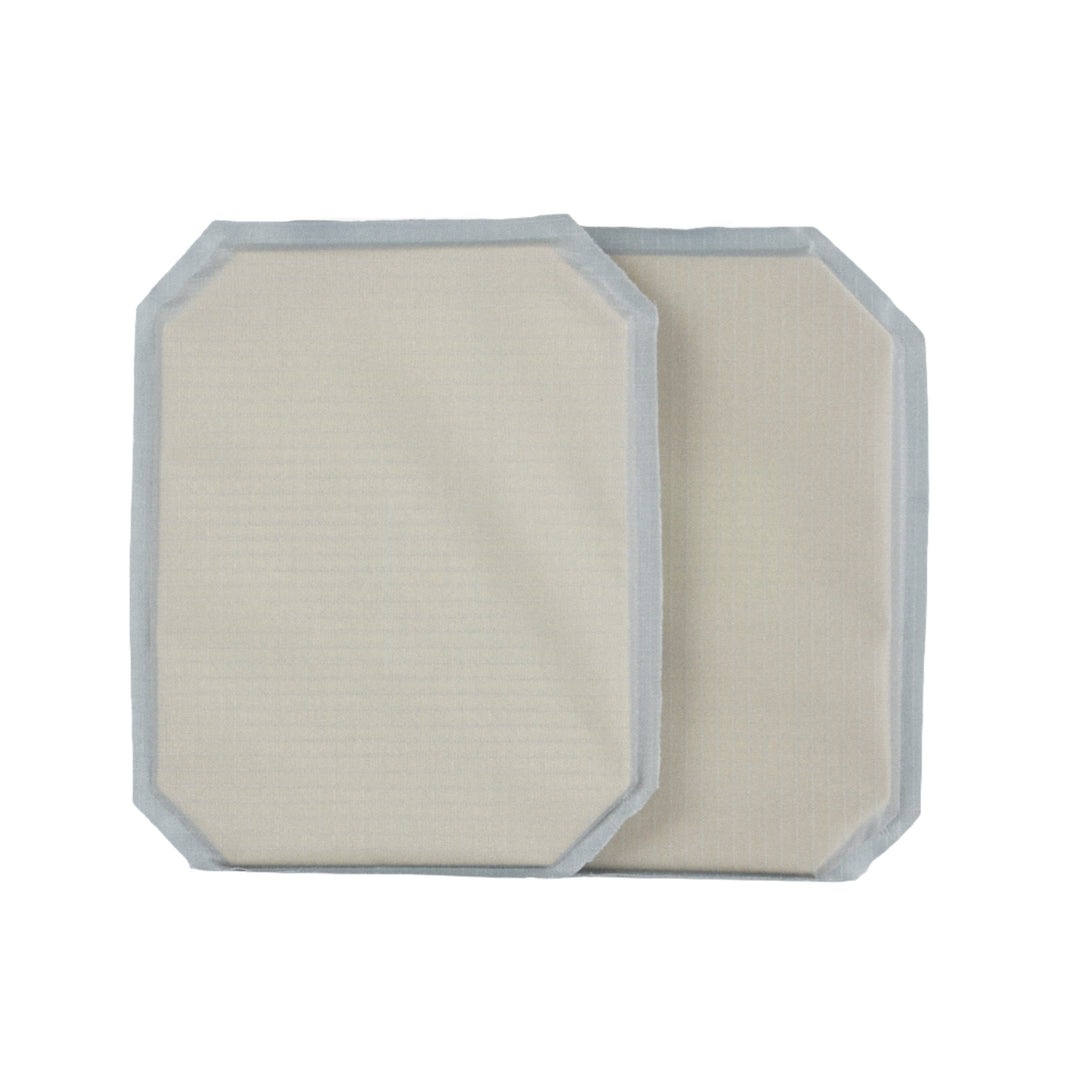 Two rectangular beige pads with grayish borders, the 6x8 Cummerbund Armor Set by Premier Body Armor, are shown overlapping on a white background. With rounded corners and soft texture, they offer Level IIIA ballistic protection.