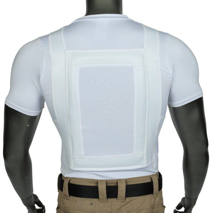 A mannequin displays a white posture corrector with a central rectangular panel and wide straps over Premier Body Armor's Everyday Armor T-shirt 360 Core and khaki pants, shown from the back. Subtle concealment channels are also visible.
