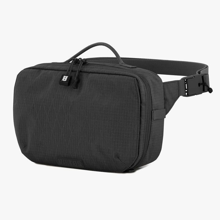 The Viktos/Premier Upscale Hip Pack is a sleek black waist bag with a zippered main compartment, top handle, adjustable buckle strap, and subtle textured pattern. It accommodates a custom-fit body armor insert for enhanced protection.