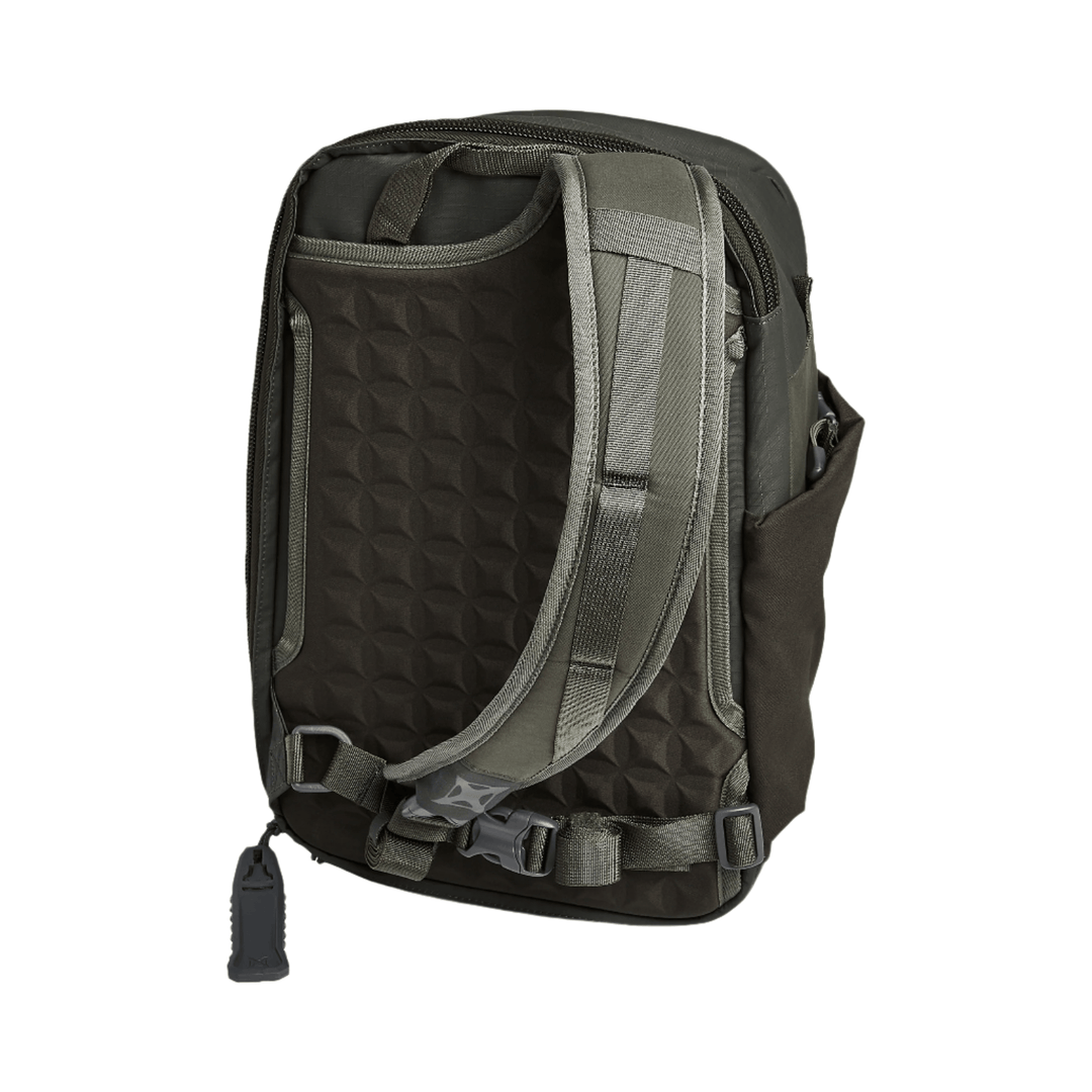 The Vertx Transit Sling 3.0 Backpack in dark green is displayed from the back, showing padded shoulder straps, a textured panel, a side pocket, buckles, and a Rapid Access Tab with an item reminiscent of a flashlight or tool attached.
