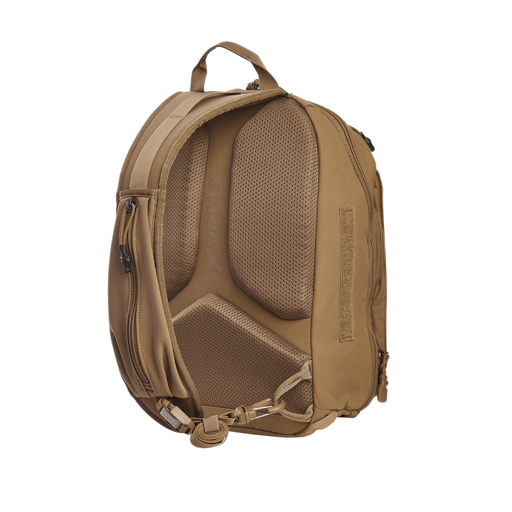 The brown backpack, similar to the Vertx Siege 15L Tactical Sling, offers ergonomic mesh padding and tactical features like a top handle, adjustable shoulder straps, side zippers, and a bottom buckle strap. The Vertx brand name is visible on the padding.