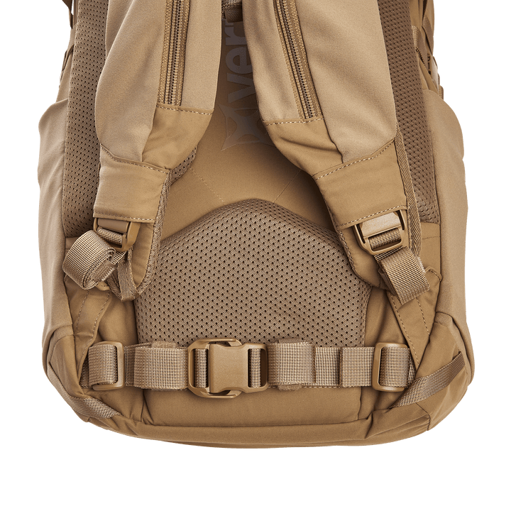 The image highlights the back and shoulder strap area of a tan backpack similar to the Vertx Siege 25L Tactical Pack. It includes mesh padding, adjustable straps with plastic buckles, and a waist strap, all made from durable material for comfort and tactical readiness.