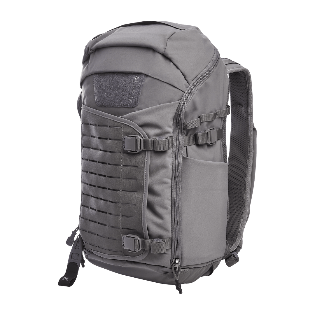 Introducing the Vertx Siege 25L Tactical Pack in Wolf Grey: a versatile backpack featuring multiple compartments, adjustable shoulder straps, and a rugged ergonomic design. Its front molle panel ensures tactical readiness, while side pockets provide extra storage.