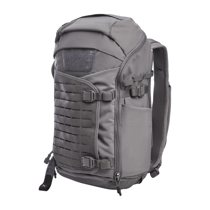 Introducing the Vertx Siege 25L Tactical Pack in Wolf Grey: a versatile backpack featuring multiple compartments, adjustable shoulder straps, and a rugged ergonomic design. Its front molle panel ensures tactical readiness, while side pockets provide extra storage.