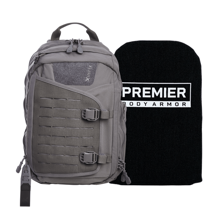 The Armored Vertx Siege Sling Bundle, a grey tactical backpack with multiple compartments and buckles, includes a Premier NIJ-Certified Level IIIA ballistic insert. This black insert fits snugly in the main compartment for enhanced security on the go.