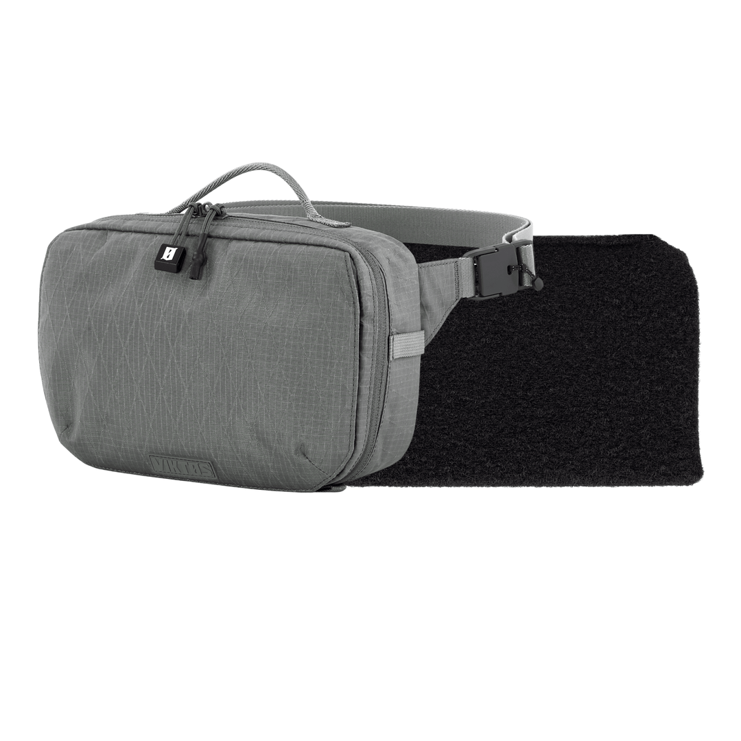 The Armored Viktos Upscale Hip Pack Bundle by Viktos/Premier is a gray sling bag with a textured design, top handle, zipper closure, and side release buckle strap on a black padded section, blending style and functionality for urban adventures.