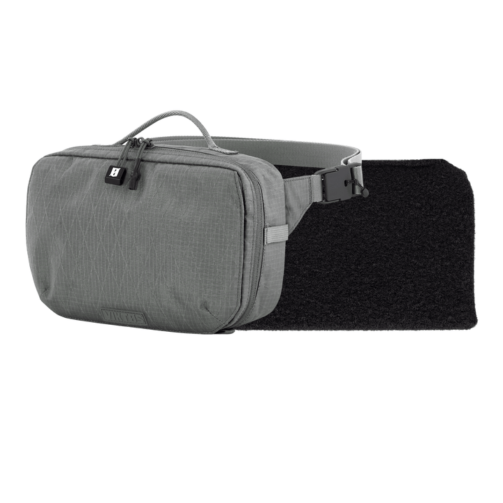 The Armored Viktos Upscale Hip Pack Bundle by Viktos/Premier is a gray sling bag with a textured design, top handle, zipper closure, and side release buckle strap on a black padded section, blending style and functionality for urban adventures.