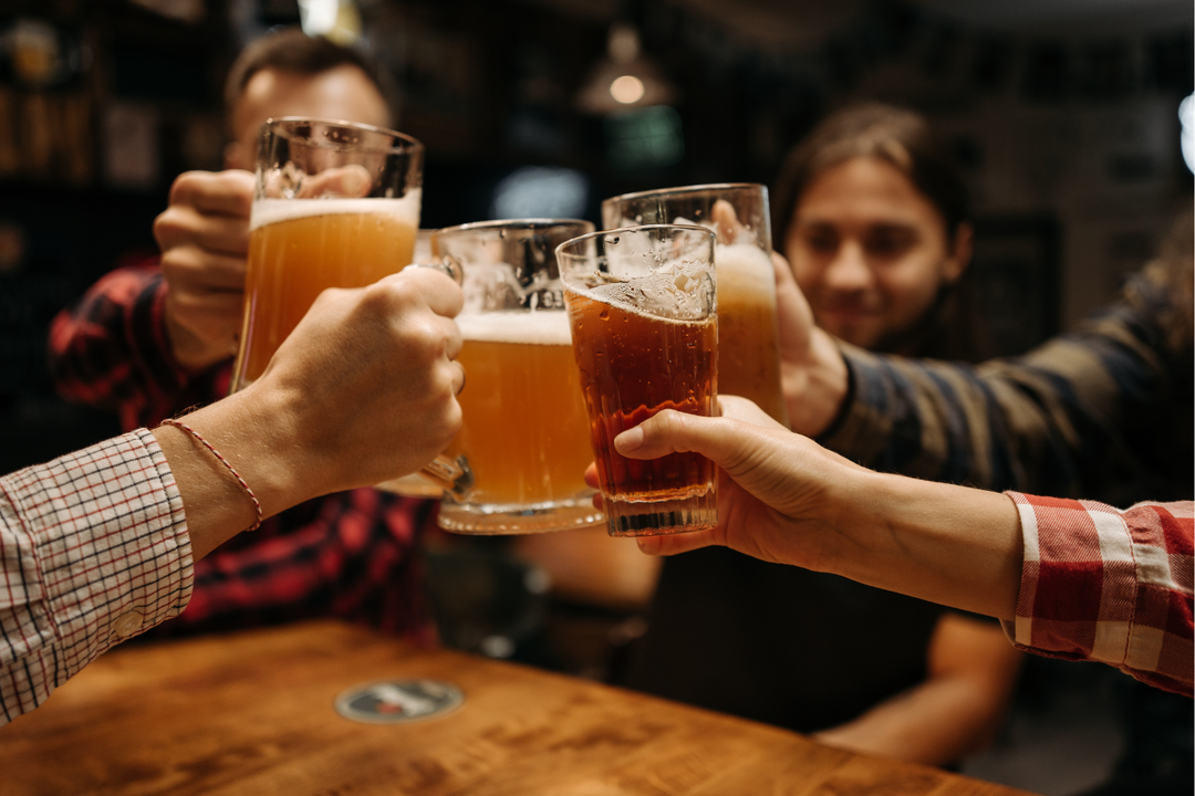 friends cheers with beers on a night out