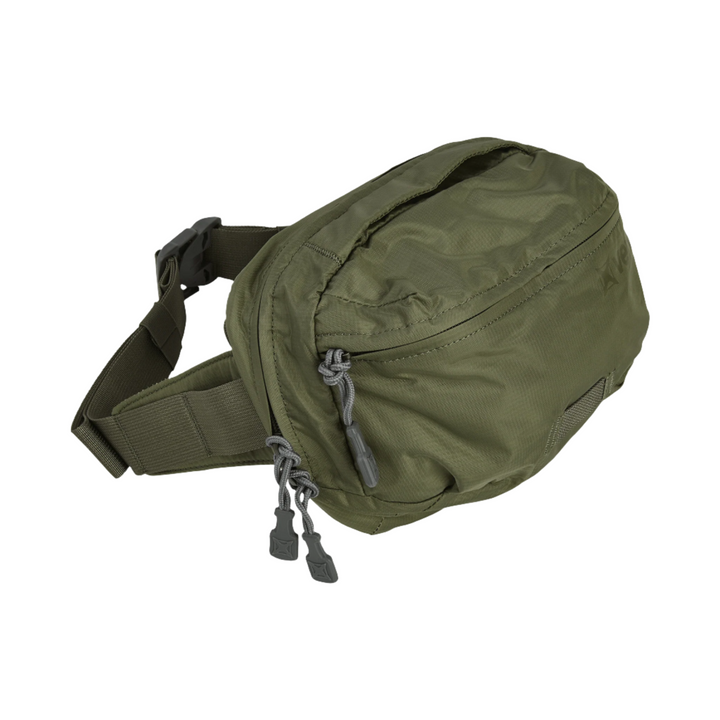 This image shows an olive-green Vertx MP Waist Pack with multiple zippers and a thick, adjustable waistband. Known for its sleek design, it features gray zipper pulls and is lightweight and durable, making it perfect for outdoor activities.