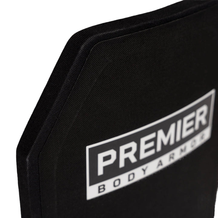 A close-up of a black Adaptable Response Loadout vest with the label "PREMIER BODY ARMOR" in white text prominently displayed on the front. The edges of the vest reveal its thick, sturdy construction featuring Fortis III+ ICW Plates. The background is plain white.