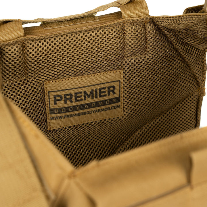 Close-up of the interior of a Fortis Level IV Loadout bag by Premier Body Armor, showcasing the brand's logo and web address on a patch stitched to the inner mesh lining. Designed for tactical flexibility, this bag features sturdy stitching and appears to be made of durable fabric.