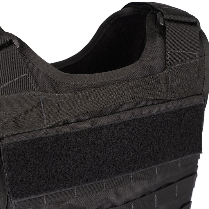 Close-up image of the Premier Body Armor Hybrid Tactical Vest - Carrier Only. The vest features adjustable shoulder straps and multiple attachment points. A large velcro panel is visible on the front, designed for attaching patches or additional equipment. The durable fabric and Level IIIA protection ensure both safety and reliability.