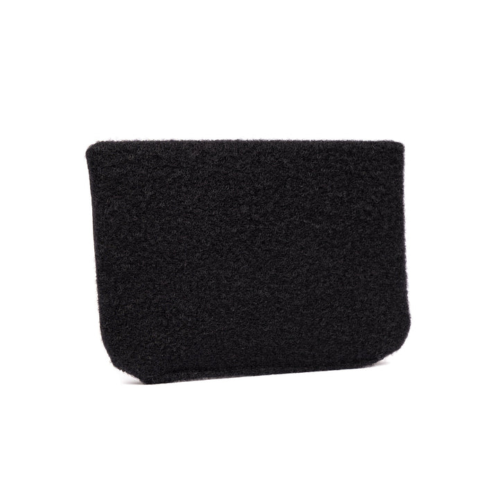 The SOE FUPA Level IIIA Insert by Premier Body Armor is a black, minimalist rectangular pouch made from a fuzzy, textured fabric. It features no visible zippers, handles, or logos, maintaining a clean and simple design. For discreet protection, the pouch subtly incorporates a ballistic panel.