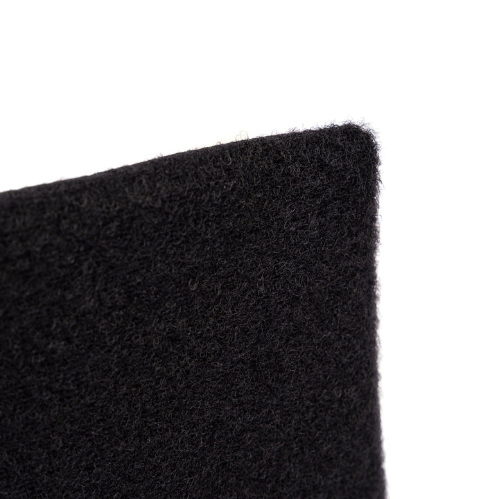 Close-up of a black textured fabric with a focus on a corner, revealing it as the ballistic material of the SOE Stacked Micro Rig Level IIIA Insert by Premier Body Armor. The fabric appears soft with a slightly fuzzy surface, and the image highlights the material's texture and thickness. The background is white and out of focus.