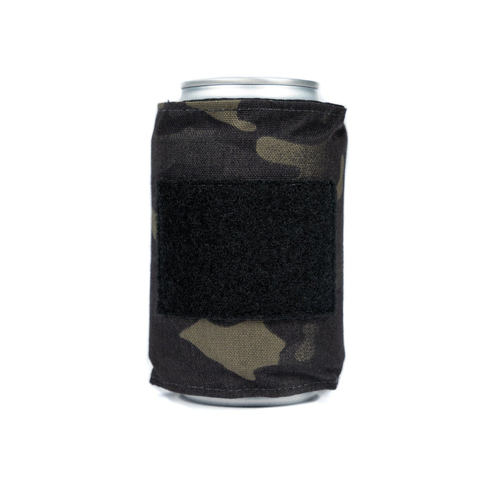 The Bulletproof Can Cooler by Premier Body Armor is a soda can sleeve with a camouflage-patterned exterior and a central black rectangular patch, crafted from ballistic material for enhanced durability.