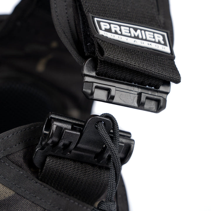 Close-up of a black strap with a buckle that reads "Premier Body Armor." The buckle, shown partially unhooked, exemplifies the durability essential for any Core Mission Plate Carrier w/ Level IIIA Cummerbund Armor tactical kit. The white background accentuates the focus on the fastening mechanism.