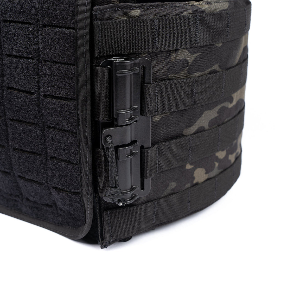 Close-up of the Premier Body Armor Core Mission Plate Carrier with Level IIIA Cummerbund Armor. The side view reveals black tactical material with a camouflage pattern, reinforced stitching, and multiple heavy-duty buckles for attaching tactical gear. The durable construction makes it well-suited for demanding environments, ensuring it is an ideal choice for rigorous use.