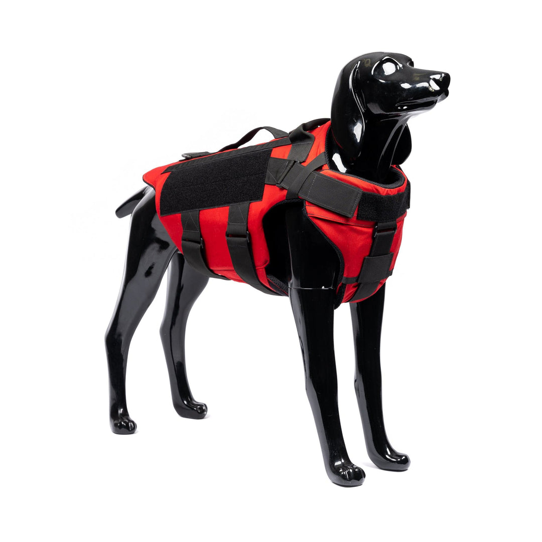 The K-9 Vest—Level IIIA by onyx/Premier Body Armor in red is displayed on a black dog mannequin, featuring handles and adjustable straps, paralleling the sleek side design and functionality of a canine life jacket.