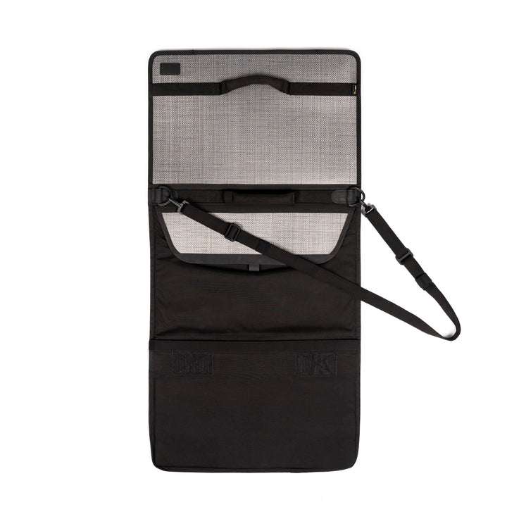 An open black foldable organizer with multiple compartments and a strap for carrying, reminiscent of the Premier Body Armor Ballistic Briefcase. The organizer features a mesh pocket, several elastic bands, and Velcro closures. The item is laid flat on a white background.