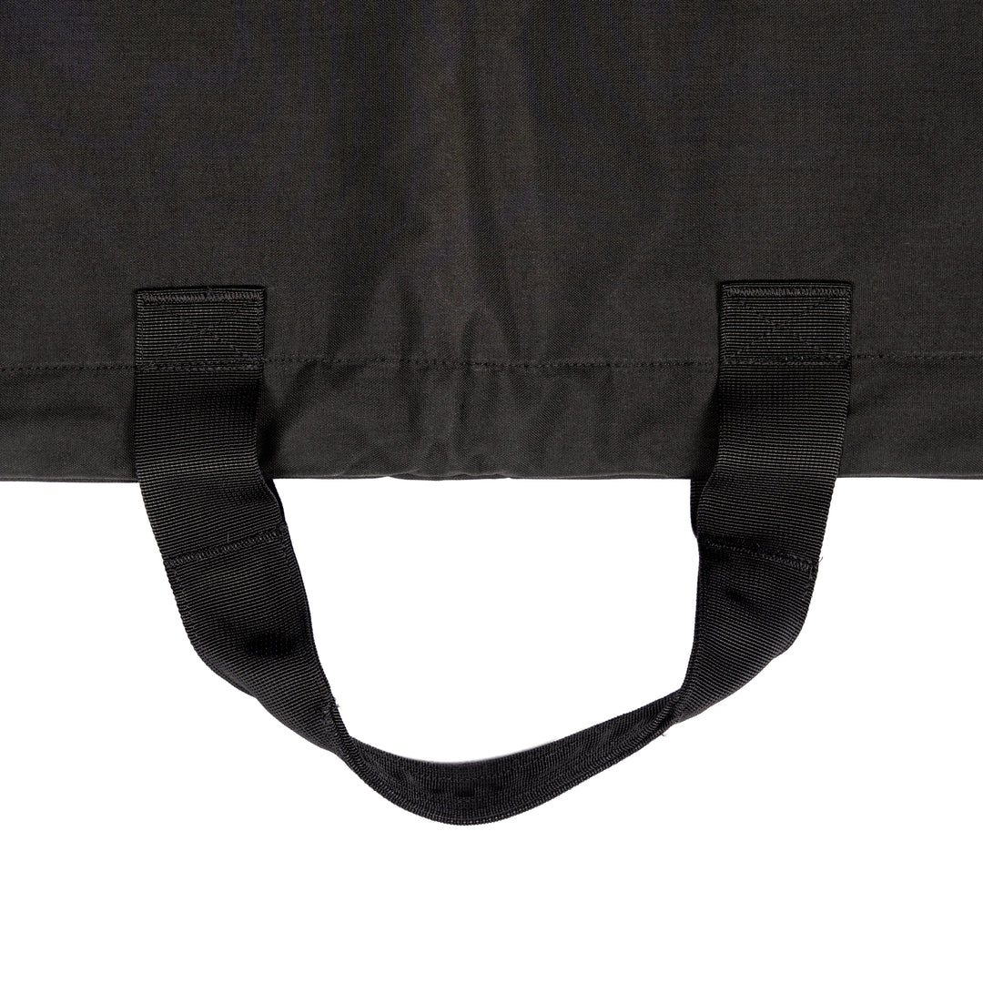 A close-up of the Fortis Ballistic Blanket, a black fabric piece crafted from durable Dyneema® by Premier Body Armor, featuring two sturdy black handles attached at the top. The visible stitching along the edges attests to its quality. The background is plain white, highlighting the blanket's sleek design.