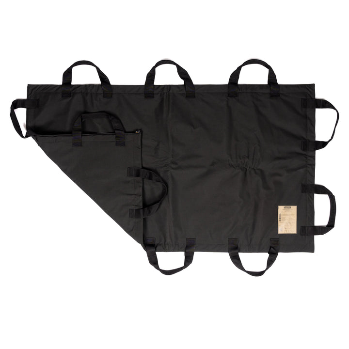 The black bag shown in the image has six carrying handles on each side and features a zippered closure along the left side. It includes a tag with information at the bottom right corner and is made from durable, waterproof fabric similar to the materials used in Premier Body Armor's Fortis Ballistic Blanket for enhanced resilience.