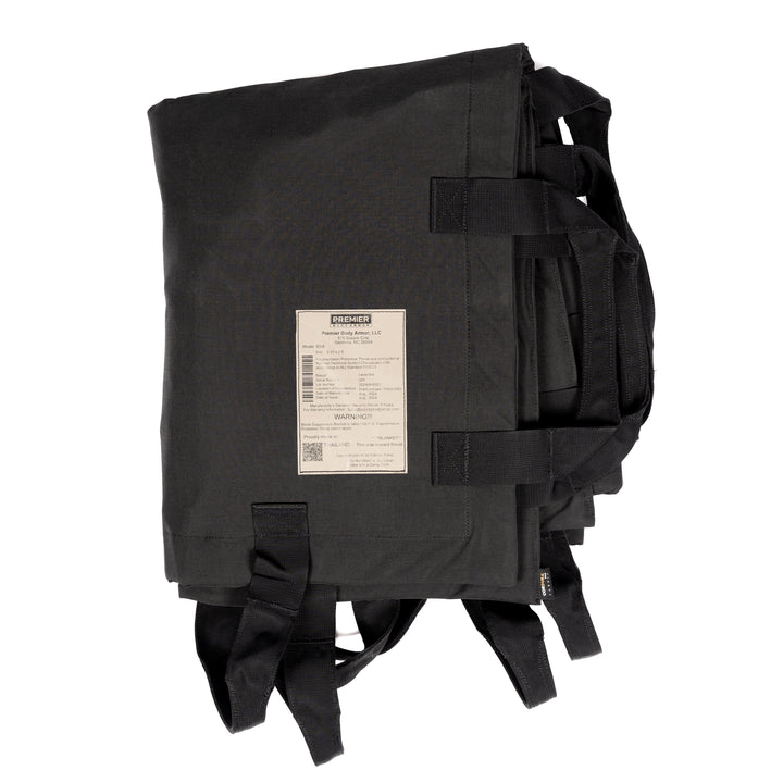 A folded, black Fortis Ballistic Blanket by Premier Body Armor is crafted from durable Dyneema®, featuring multiple straps and a white label with text and a barcode. Its minimalist design exudes a utilitarian vibe, ideal for those who value both style and resilience in their gear.