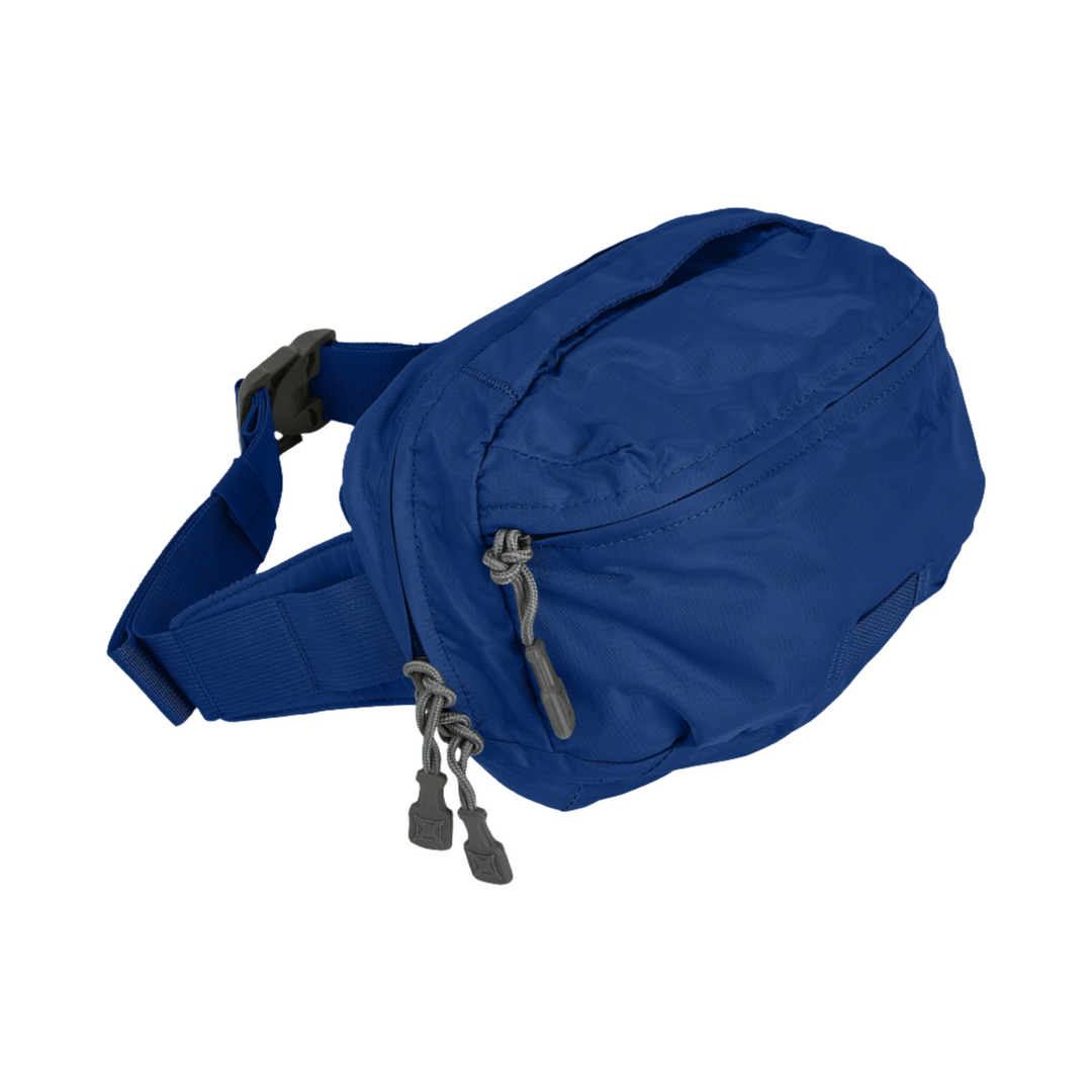 The Vertx MP Waist Pack is a blue fanny pack with a zippered main compartment and additional small zippers on the front. It features an adjustable strap with a gray buckle and two gray zipper pulls. Made of lightweight material, the Vertx MP Waist Pack appears compact and functional for daily use.