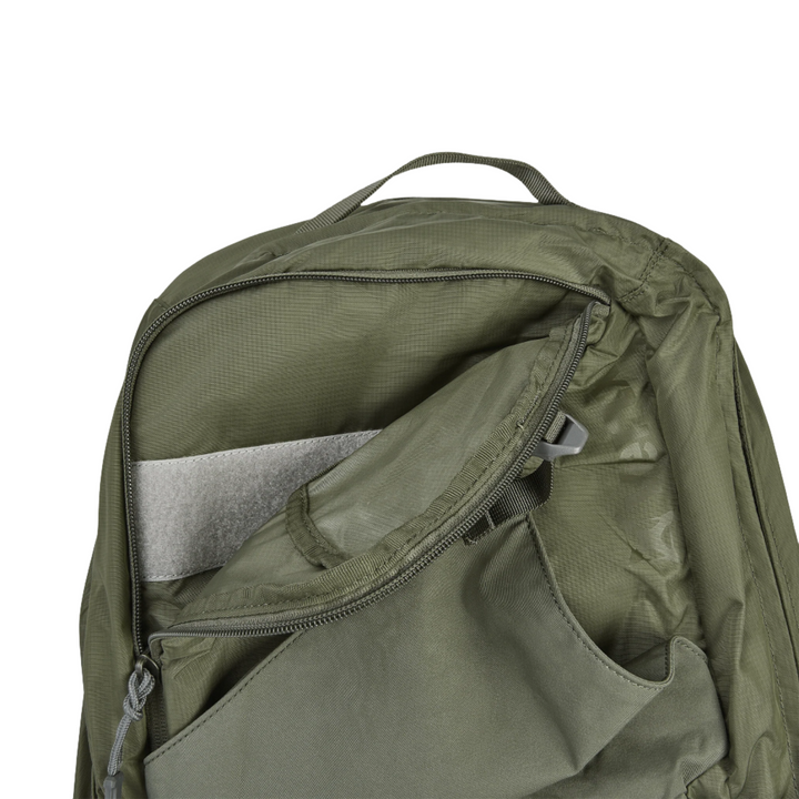 The Vertx Long Walks Pack 28L in olive green is shown partially open against a plain background. The open zipper reveals multiple compartments, including a padded slot suitable for a laptop or tablet and space for a body armor insert. A small carry handle is visible at the top of the backpack.