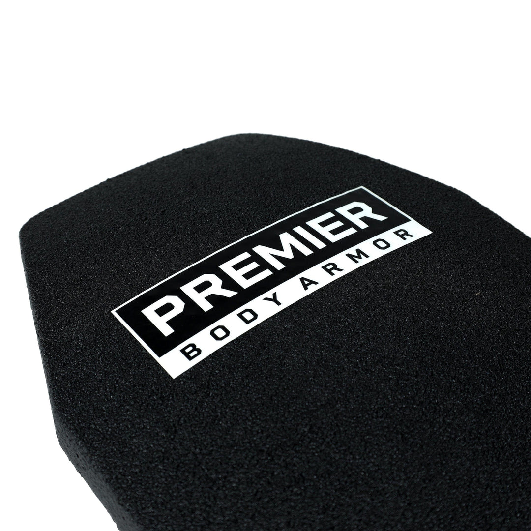 A close-up view of the Premier Body Armor's STRATIS Level III+ MC black armor plate features the brand's label prominently in white and black at the center. The textured surface of the plate highlights its superior personal protection rating.