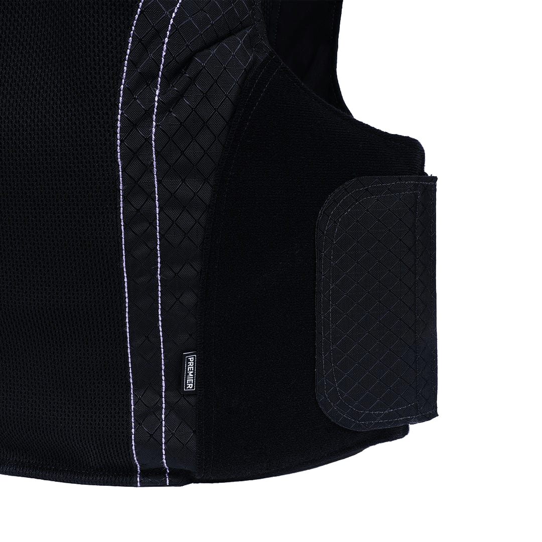 Close-up view of the Female Concealable Armor Vest - Carrier Only by Premier Body Armor, showcasing its black quilted and mesh fabric sections. The vest features antimicrobial fabric and a Velcro strap on the side for adjustment.