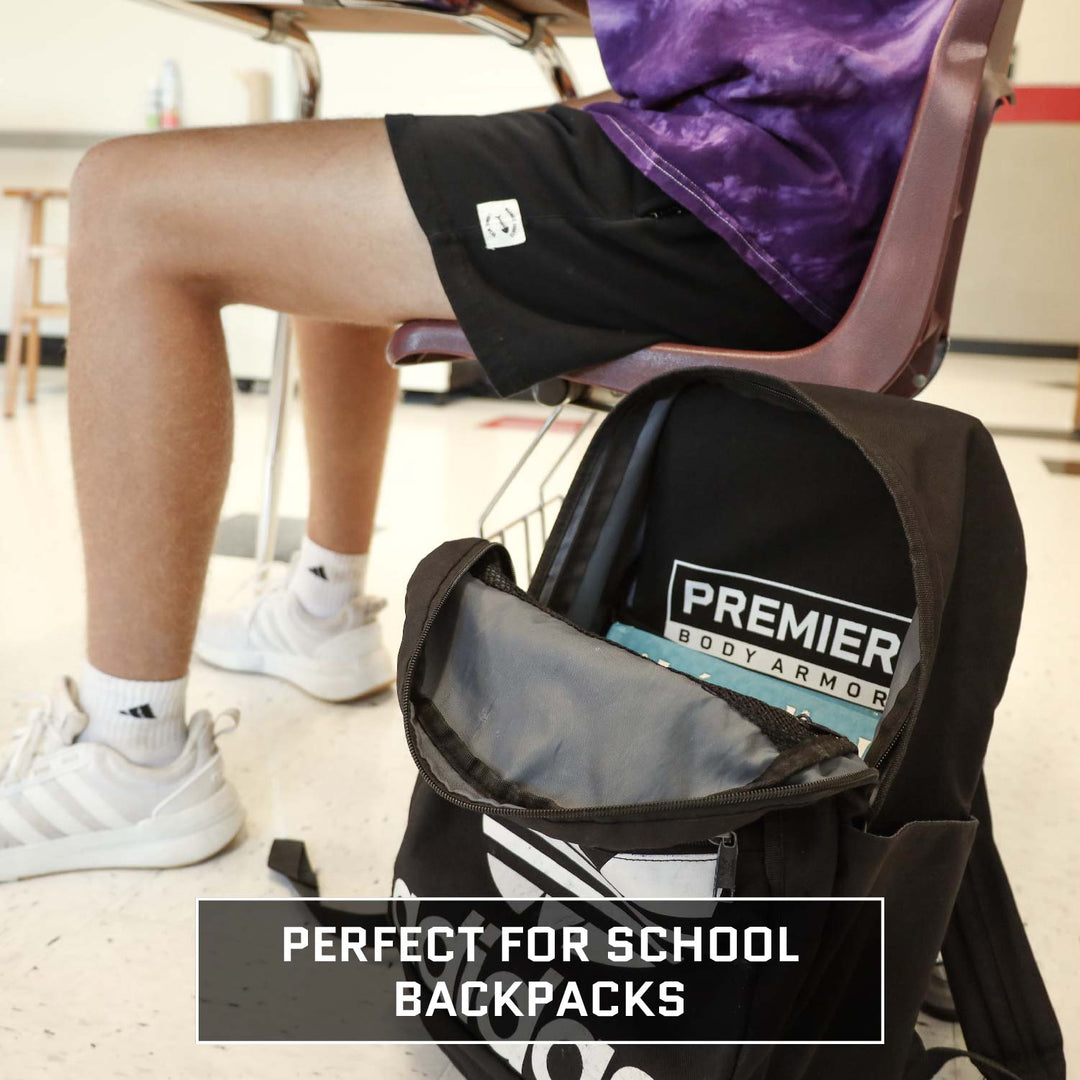 student in desk with backpack armor in school backpacks