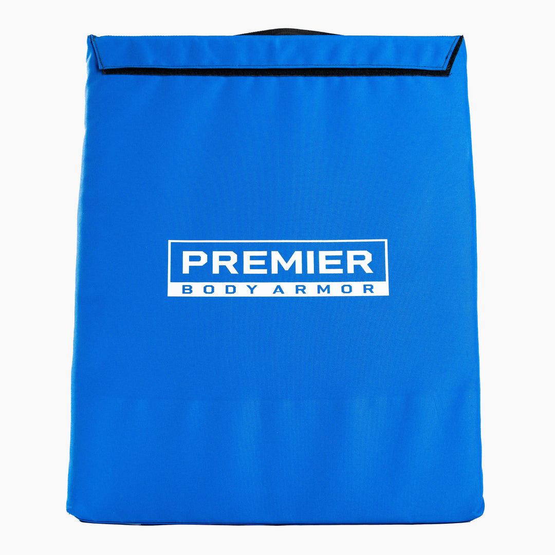 A rectangular blue body armor panel with a handle at the top, called the First Aid Shield. Ideal for school safety, this panel features the text "PREMIER BODY ARMOR" in white in the center and serves as a Level III+ School Shield.