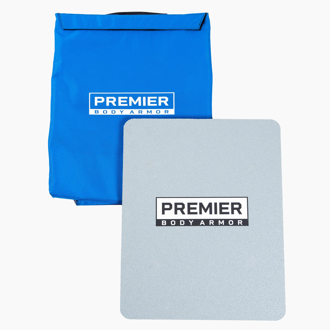 A piece of body armor and a blue carrying case are displayed. Both items feature the "Premier Body Armor" logo. The rectangular Level III+ First Aid Shield is placed in front of the blue case, which is partially open at the top. This setup ensures school safety and serves as an essential emergency response kit.
