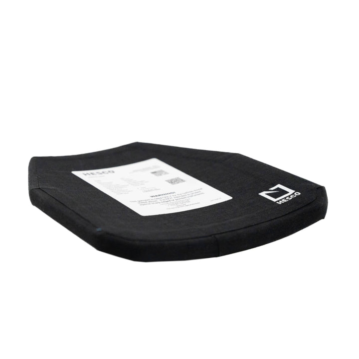 The HESCO L211 Special Threat Plate is a black ballistic plate by Hesco, featuring a white label with printed information, a rectangular shape with slightly curved edges, and the brand logo in the bottom right corner. Its lightweight ceramic/composite design ensures durability.