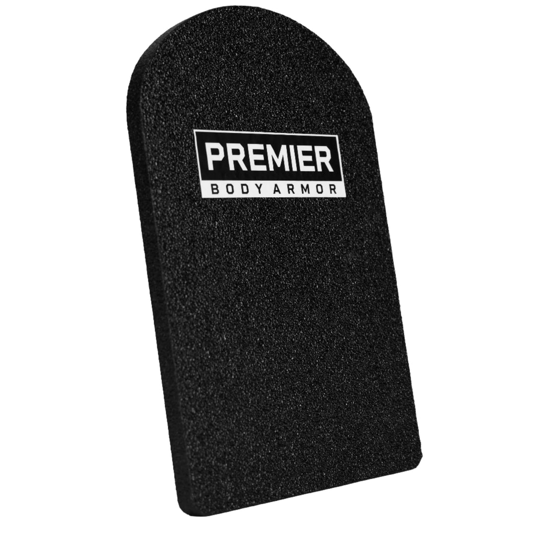 A black ballistic plate labeled "Premier Body Armor" stands against a white background. Designed as a Universal Fit Level III+ Rifle-Rated Backpack Insert, it has a rectangular shape with a semicircular top, offering discreet protection and meeting NIJ ballistic standards.