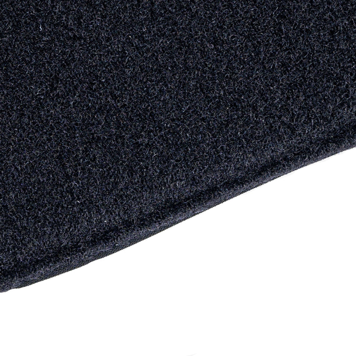 Close-up of dark, textured fabric with a visible edge in the bottom right against a white background, resembling the thick material of the Armored Viktos Upscale Hip Pack Bundle by Viktos/Premier.