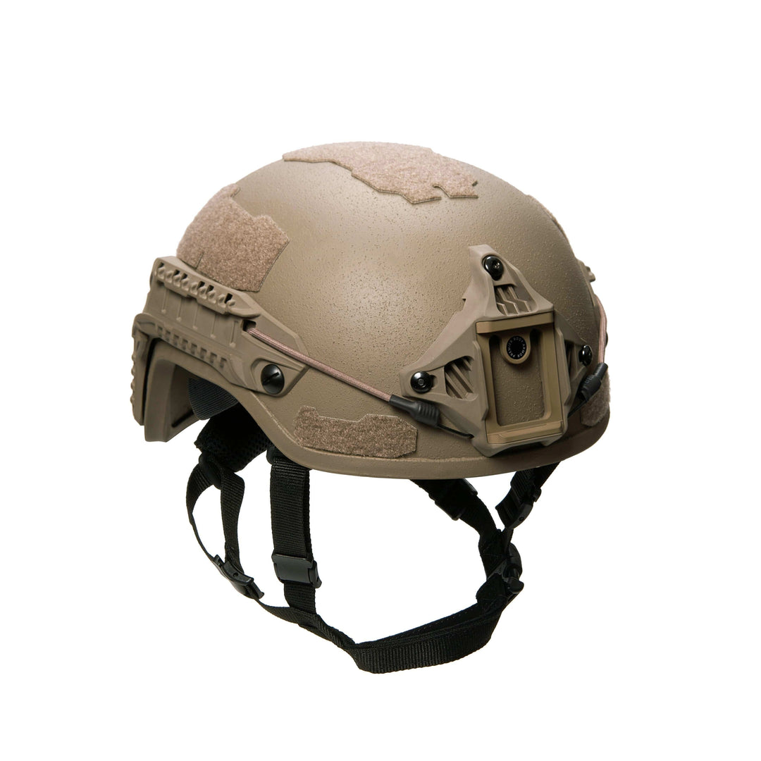 The Fortis Ballistic Helmet by Premier Body Armor is a matte tan tactical helmet with black chin straps and Velcro patches, made from lightweight ballistic fibers. It offers advanced protection and includes a front mount for accessories.