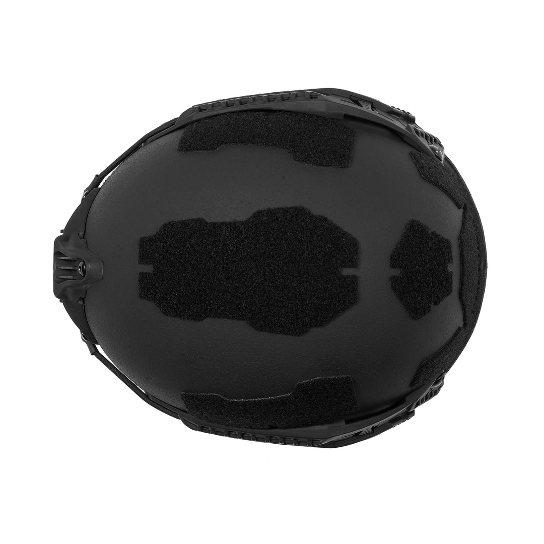 The Fortis Ballistic Helmet by Premier Body Armor features a top view highlighting its advanced protection. This black, lightweight helmet has a textured surface with attachment points, smooth contours, and Velcro patches for customizable accessories.