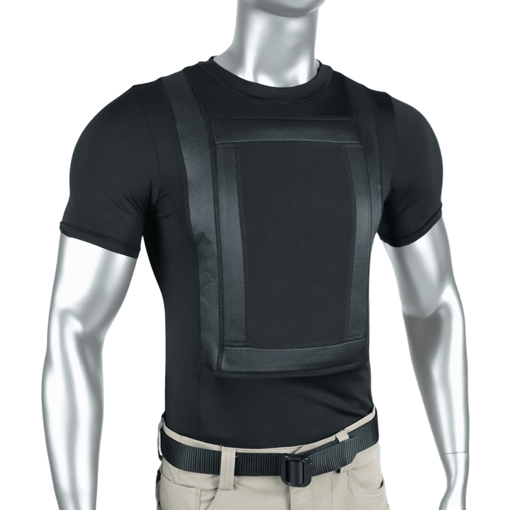 A silver mannequin wears the Premier Body Armor Everyday Armor T-shirt 360 Core, a fitted black tee with a textured chest panel and straps for concealed armor, paired with beige pants and a black belt.