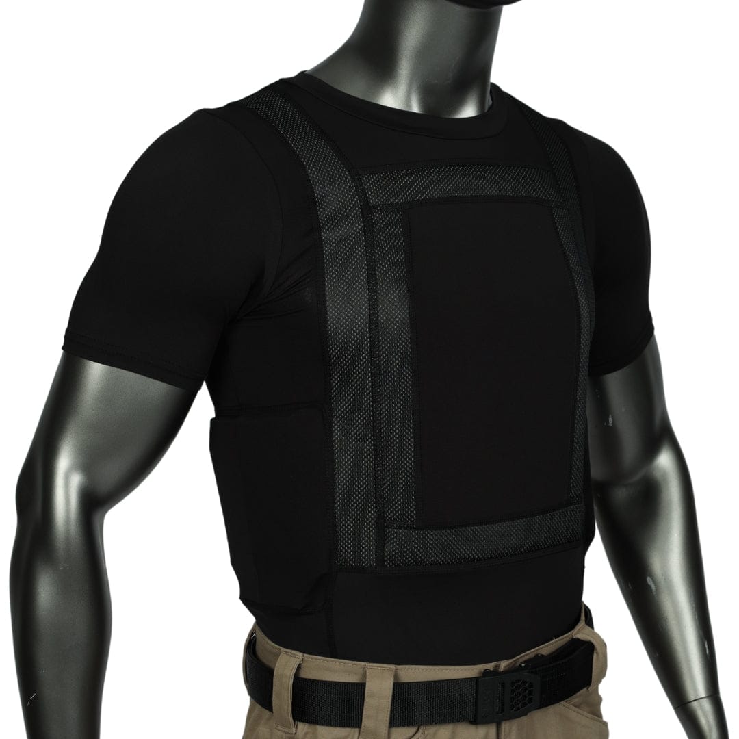 A mannequin is shown from the chest up wearing Premier Body Armor's Everyday Armor T-Shirt 360 (Armored) in black under a black tactical vest, paired with khaki pants and a black belt. Visible stitching and panel details complete the look.