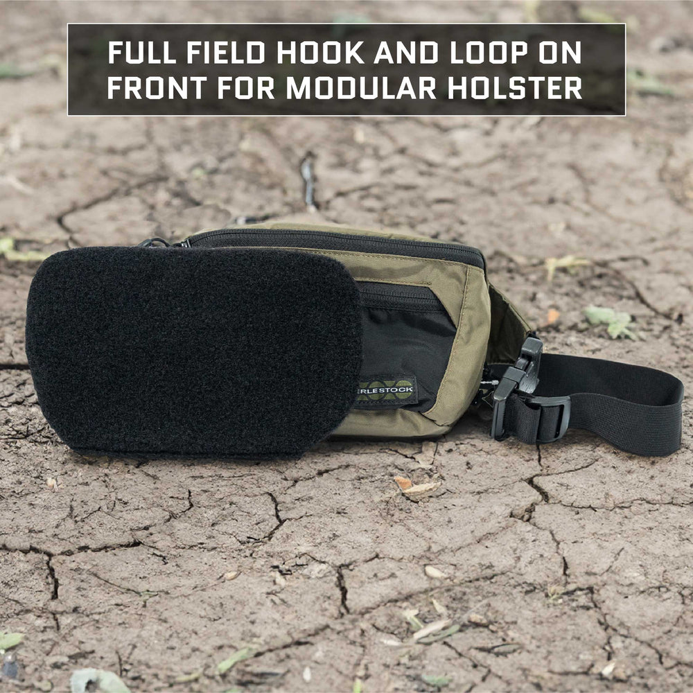 A tactical Eberlestock Bando Bag Level IIIA Insert from Premier Body Armor, featuring a black hook and loop panel for a modular holster, is placed on the dry, cracked ground. The detachable panel is displayed in front of the bag, conforming to NIJ ballistic standards, with a striking slogan in the background of the image.