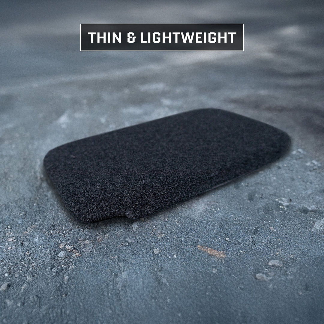 A thin, black Eberlestock Fade Flex Level IIIA Insert by Premier Body Armor rests on a textured gray surface. Text above reads "THIN & LIGHTWEIGHT," highlighting its innovative design for seamless integration into any backpack armor setup.