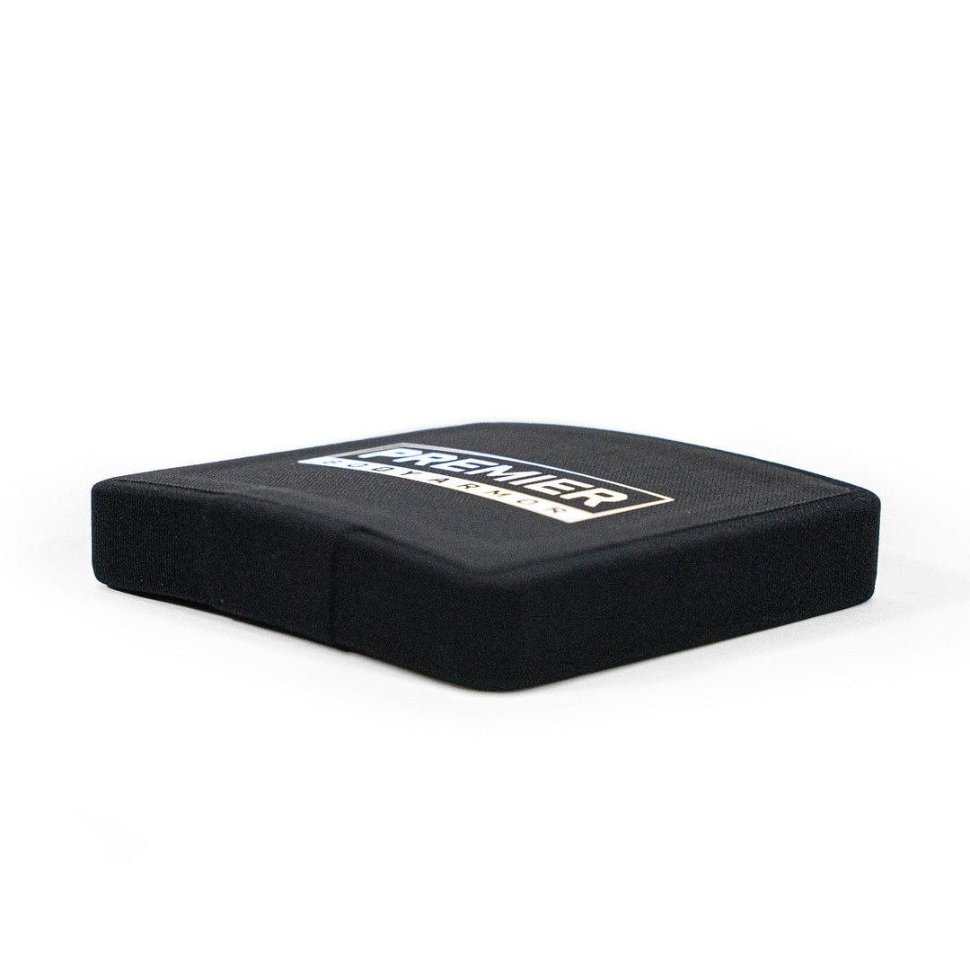 Black square seat cushion with a slight center indentation and textured surface, branded with Premier Body Armor's logo, showcasing its reliability and affordability. Ideal for comfort, it elegantly rests on a plain white background.