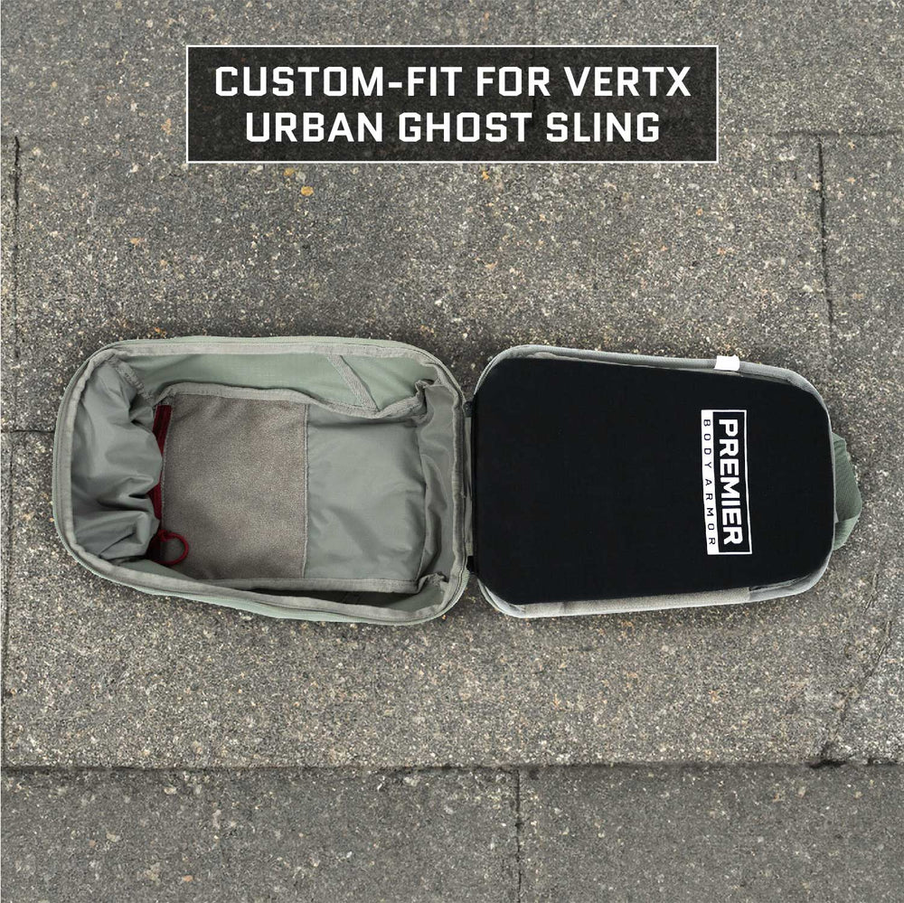 An open bag rests on a concrete surface, revealing its interior equipped with a compartment housing a gray fabric item. Text on the image states, "Custom-fit for Vertx Urban Ghost Sling," featuring a ballistic insert that provides Level IIIA protection, with an inside label saying "Premier Body Armor.