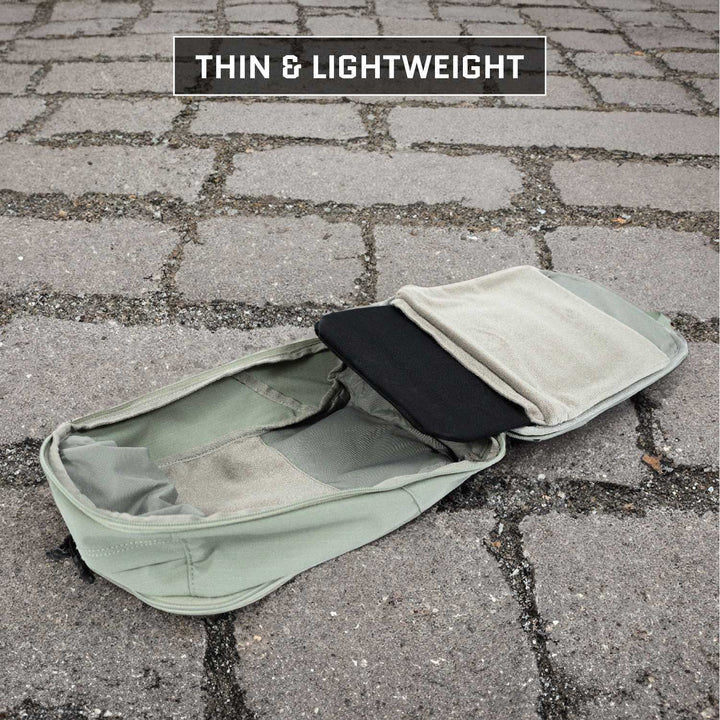 A light green Vertx Ghost Sling Level IIIA/HG2 Backpack Insert by Premier Body Armor, featuring open compartments, is lying on a cobblestone surface. A black ballistic panel is partially visible inside the backpack. Above it, the text reads "THIN & LIGHTWEIGHT.