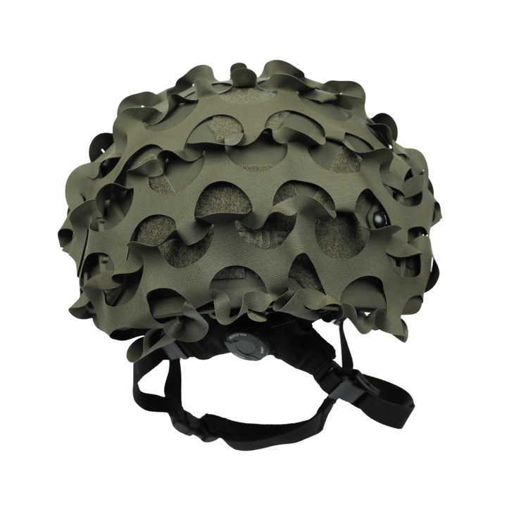 The OPE Gear Helmet Scrim - Camo Helmet Cover by OPE Gear features irregular, wavy cutouts and fits over military helmets with a matte green finish, offering compatibility with ACH helmet accessories and adjustable black chinstraps.